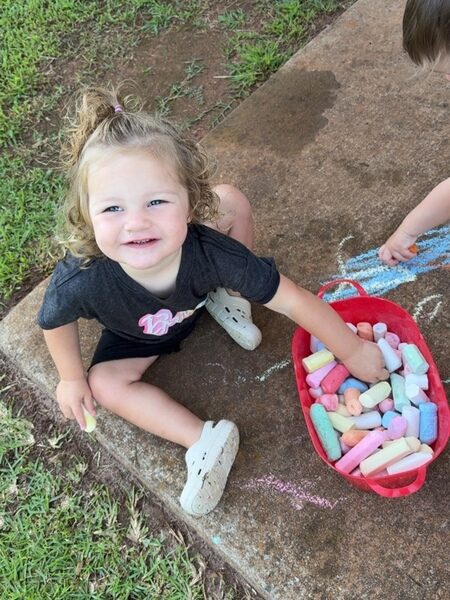Smarr girl playing with chalk