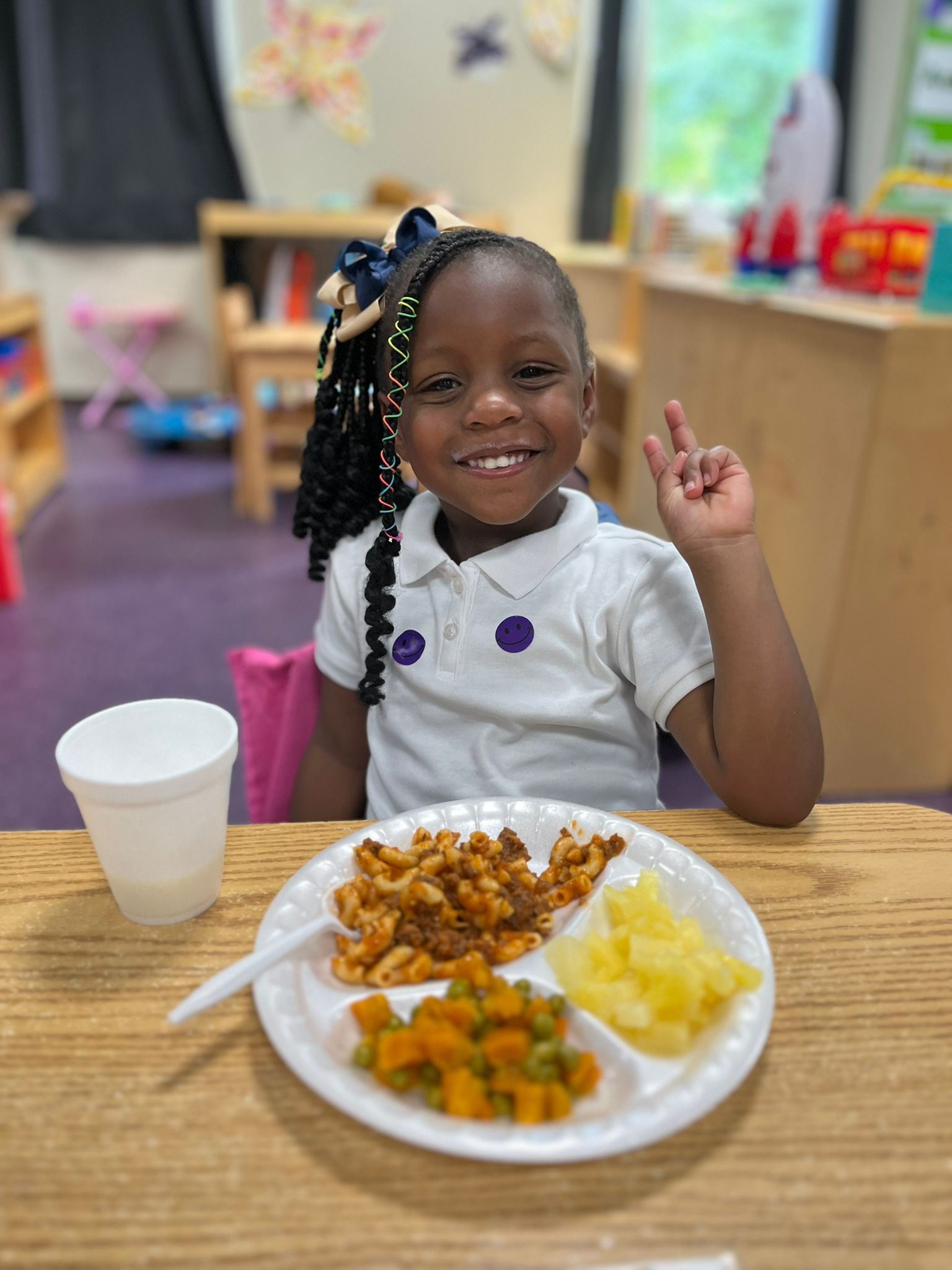 Savannah girl raising peace sign