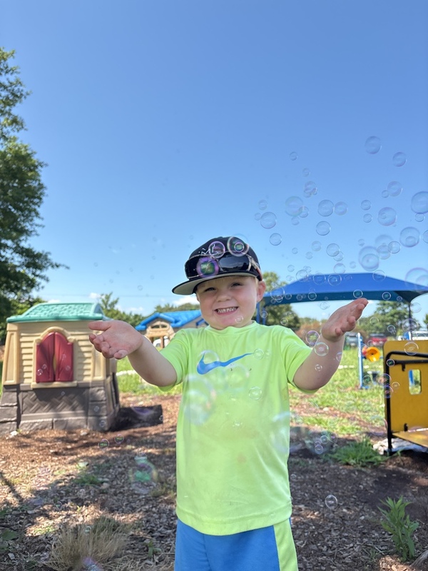 Smarr boy playing with bubbles