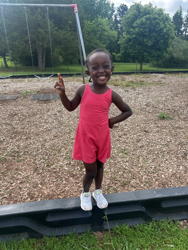 Smarr girl holding up peace sign