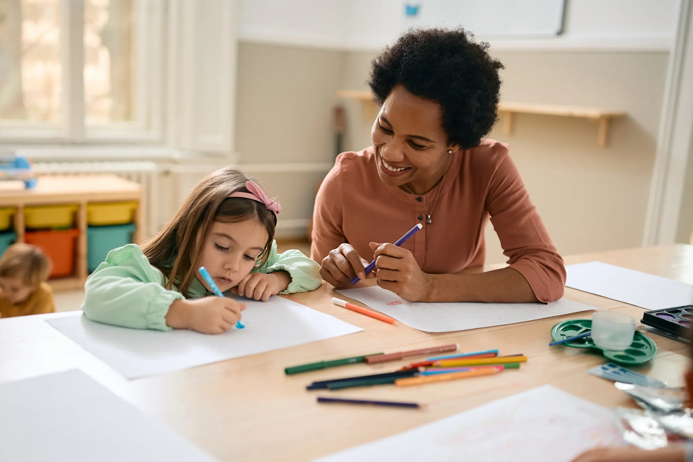 A teacher helping a student with homework.