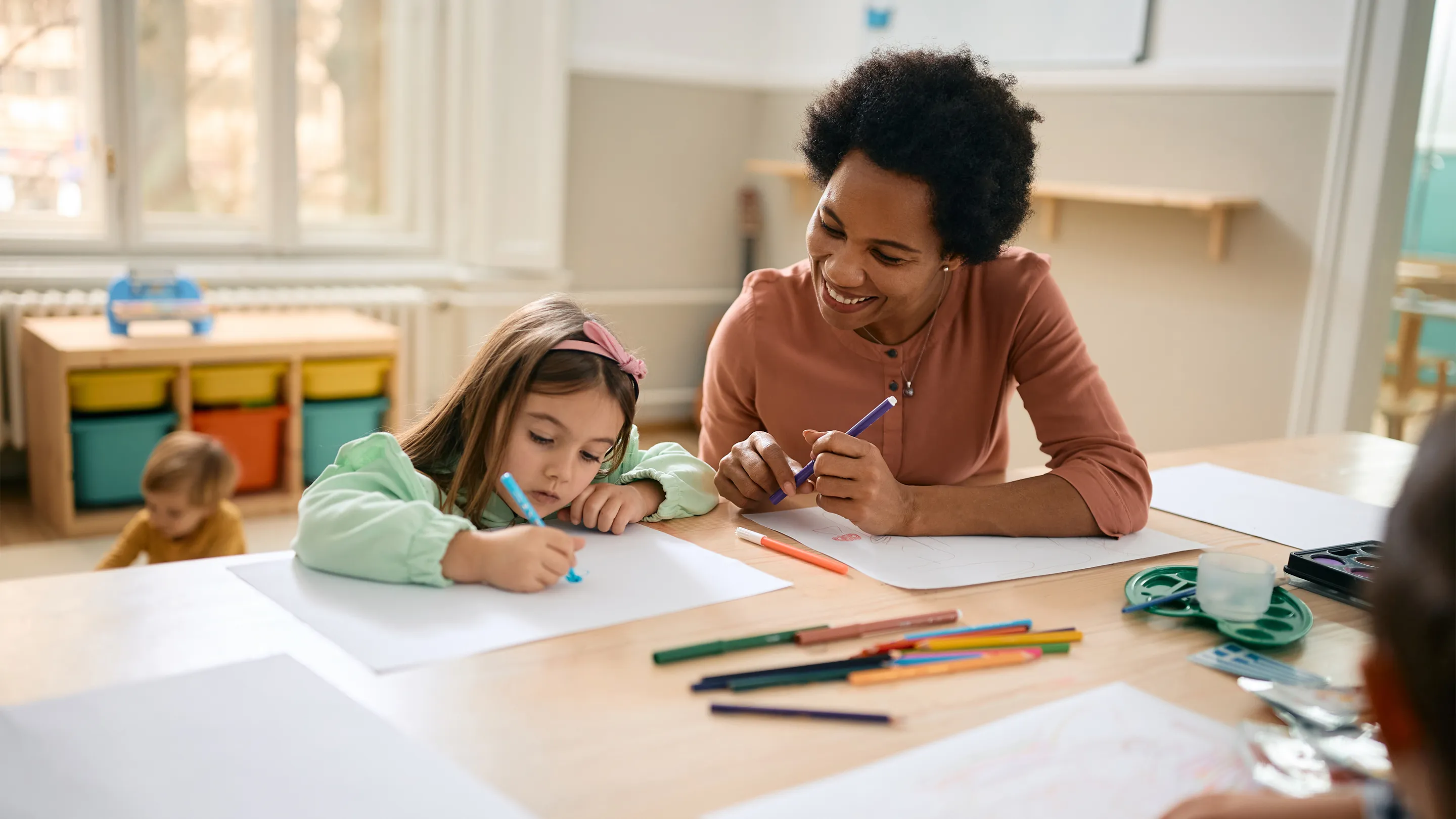 A teacher helping a student with homework.